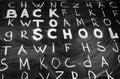 Back to school background with title Back to school among other letters of English alphabet written by white chalk on Royalty Free Stock Photo