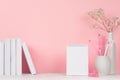 Back to school backgrounds for girl - white and pink stationery, books, blank notepad on white wood table and pink wall.