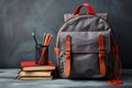 Back to school Backpack with books and pencils on gray background Royalty Free Stock Photo