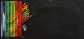 Back to school banner. Rainbow pencil case with school supplies for student. Black background. Copy space