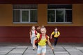 Schoolchildren run from school. Classmates with backpacks. Back to school Royalty Free Stock Photo