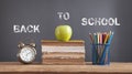 Back To School. Books, alarm clock, apple, pencils Royalty Free Stock Photo