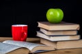 Back to school. Books, green apple, pencils and glasses on wooden table Royalty Free Stock Photo