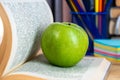 Back to school. Books, green apple, pencils and glasses on wooden table Royalty Free Stock Photo