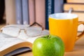 Back to school. Books, green apple, pencils and glasses on wooden table Royalty Free Stock Photo