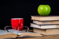 Back to school. Books, green apple, pencils and glasses on wooden table Royalty Free Stock Photo