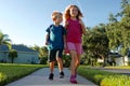 Back to school: Boy and girl walking with backpacks Royalty Free Stock Photo