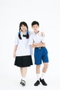 Back to School. Boy and girl wearing high school uniforms of Thailand. Children on white background