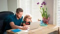 back to school. busy father and son in glasses use computer at home. family blog. Royalty Free Stock Photo