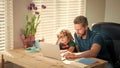 back to school. busy father and son in glasses use computer at home. family blog. Royalty Free Stock Photo