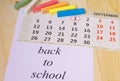 Back to school, calendar, colored chalk on wooden background