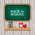 Back to school chalk with green chalkboard with clock, pencil case, apple, ruler, on the shelves