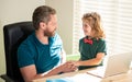 back to school. cheerful dad and son in glasses use laptop at home. family blog. nerd boy Royalty Free Stock Photo