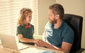 back to school. cheerful dad and son in glasses use laptop at home. family blog. nerd boy Royalty Free Stock Photo