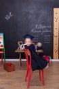 Back to school! Cheerful little girl is sitting on the lesson. Looking into the camera. School concept. School Girl responds to th Royalty Free Stock Photo