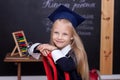 Back to school! Cheerful little girl is sitting on the lesson. Looking into the camera. School concept. School Girl responds to th Royalty Free Stock Photo