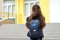 Back to school. Child going school after pandemic over.Portrait of a schoolgirl with a backpack from the back against the Royalty Free Stock Photo