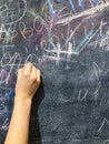 A child paints by chalk on a school board Royalty Free Stock Photo