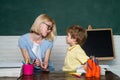 Back to school. Child and teacher near chalkboard in school classroom. Great study achievement. School lessons. Royalty Free Stock Photo
