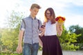 Back to school, Children teenagers go first day to school, with bouquet of flowers, smile, talk. Royalty Free Stock Photo