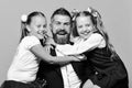 Back to school and classroom concept. Kids wearing school clothes and bows sitting near bearded teacher