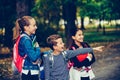 Close up three happy friends with backpacks looking and pointing with finger away Royalty Free Stock Photo