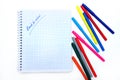 Back to school. Colorful markers and a notebook. A top flatly view of a white children`s desk with colourful markers.