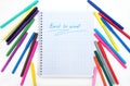 Back to school. Colorful markers and a notebook. A top flatly view of a white children`s desk with colourful markers