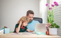 back to school. comcentrated father and son use computer at home. family blog. Royalty Free Stock Photo