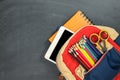 Back to school concept. Backpack with school supplies, tablet and against chalk board. Top view. Copy space Royalty Free Stock Photo