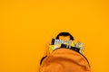 Back to school concept. Backpack with school supplies on yellow background. Top view. Copy space. Flat lay Royalty Free Stock Photo