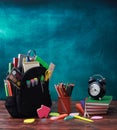Back to school concept. School bag, pencils, crayons, scissor, notebooks, alarm clock, eraser, markers, watermark, ruler, pencil s
