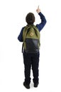 Back to school concept. Beautiful schoolboy with backpacks pointing at wall. Back view. Isolated on white background. Full length.