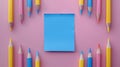 A blue color post it paper, pink, blue and yellow pencils on pastel pink. Royalty Free Stock Photo