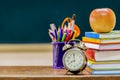 Back to school concept. the book is stacked and has a pencil case,Alarm Clock and red Apple. Royalty Free Stock Photo