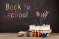 Back to school concept - books on the desk over the blackboard Royalty Free Stock Photo
