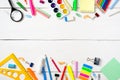 Back to school concept, border frame of colorful stationery supplies for teaching kids drawing on empty white wooden desk. Royalty Free Stock Photo