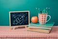 Back to school concept with chalkboard, books and apple Royalty Free Stock Photo