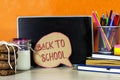 Back to school concept - chat bubble and blackboard with pencil-box and books, notebook and sticky note, milk and cookies