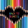 Back to school concept. Colorful pencils arranged as heart on black background.