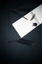 Back to school concept with colour pencils, ink bottle and notepad on black background Royalty Free Stock Photo