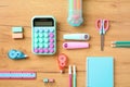 Back to school concept. Creative layout with calculator, proofreader, markers, scissors, pencils, notepad, eraser, ruler on wooden Royalty Free Stock Photo