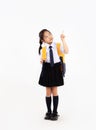 Back to school concept. Cute asian junior school student kid in uniform with yellow backpack posing finger pointing Royalty Free Stock Photo