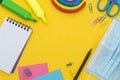 Back to school concept. Face mask, colorful pencils, rainbow eraser, notebook, sticky notes and office supplies. Flat Royalty Free Stock Photo