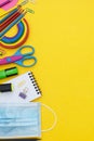 Back to school concept. Face mask, colorful pencils, rainbow eraser, notebook, sticky notes and office supplies. Flat Royalty Free Stock Photo