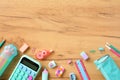Back to school concept. Flat lay composition with school supplies in pink and turquoise colors on wooden desk. Top view calculator Royalty Free Stock Photo