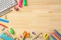 Back to school concept. Frame border of colorful school supplies on wooden desk table. Flat lay, top view Royalty Free Stock Photo