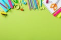 Back to school concept. Frame border made of school supplies on green background Royalty Free Stock Photo
