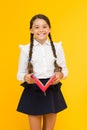 Back to school concept. Girl hold book. School girl on yellow background. Practice and improve reading skills for school Royalty Free Stock Photo