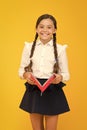 Back to school concept. Girl hold book. School girl on yellow background. Practice and improve reading skills for school Royalty Free Stock Photo